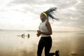 Afro American woman running on the beach - young attractive and athletic black girl training outdoors doing jogging workout at the Royalty Free Stock Photo