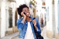 Afro american woman talking on mobile phone and smiling outdoors Royalty Free Stock Photo