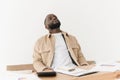 Afro american young man very frustrated with family budget problems while checking bank papers or tax forms. Royalty Free Stock Photo