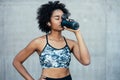 Athletic woman drinking water after work out outdoors. Royalty Free Stock Photo