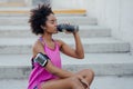 Athletic woman drinking water after work out outdoors. Royalty Free Stock Photo