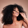 Afro, beauty and face of black woman with hair in hands on brown background for wellness, shine and natural glow. Salon Royalty Free Stock Photo