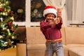 Afro boy holding Christmas petard. Royalty Free Stock Photo