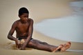 Afro Brazilian boy digging a hole in sand