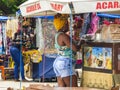 Afro Brazilian woman with a turban buying an Acaraje popular snack in Bahia