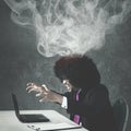 Afro businessman angry with his broken laptop Royalty Free Stock Photo