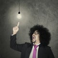 Afro businessman pointing light bulb Royalty Free Stock Photo