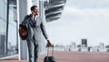 Afro Businessman Walking With Luggage And Talking On Phone Royalty Free Stock Photo