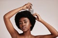Afro comb, black woman and portrait of a model with hair care, salon and cosmetics. Hairdresser comb, African hairstyle