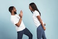 Afro couple arguing, woman yelling at scared man