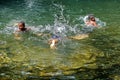 Children playing in a pool at the base of a waterfall in Ecuador Royalty Free Stock Photo