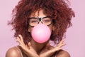 Afro girl blowing bubble gum balloon.