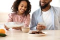 Afro Girl And Her Dad Pouring Milk In Cereal Royalty Free Stock Photo