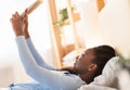 Afro Girl Using Tablet Lying In Bed In The Morning Royalty Free Stock Photo