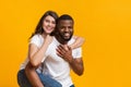 Afro guy giving piggyback ride to his girlfriend Royalty Free Stock Photo
