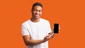 Afro guy showing blank black mobile phone screen Royalty Free Stock Photo