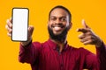 Afro guy showing blank cell phone screen Royalty Free Stock Photo