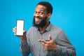 Afro guy showing blank mobile phone screen Royalty Free Stock Photo