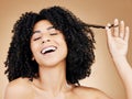 Afro, hair strand and beauty of woman in studio for natural growth, coil textures and results on brown background. Happy