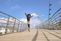 Afro hairstyle woman on roller skates riding outdoors on urban bridge