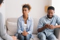 Afro Husband Playing Phone Visiting Couples Therapy With Wife