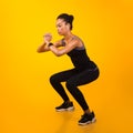 Afro Lady Exercising Doing Deep Squat Working Out, Studio Shot