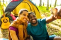 afro latin couple in tent taking selfie using modern smartphone Royalty Free Stock Photo