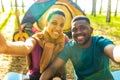 afro latin couple in tent taking selfie using modern smartphone