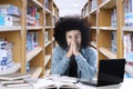 Afro male student looks tired at library