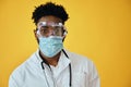 Afro Male Surgeon Wearing Protective Face Mask And Eyewear Royalty Free Stock Photo