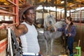 Afro man horse farm worker Royalty Free Stock Photo