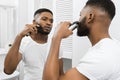 Afro man shaving his face Royalty Free Stock Photo