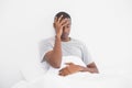 Afro man suffering from headache in bed Royalty Free Stock Photo