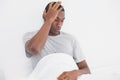 Afro man suffering from headache in bed Royalty Free Stock Photo