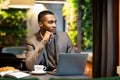 Afro manager looking out of window in cafe