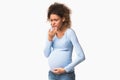 Afro pregnant lady feeling sick, having nausea on white background