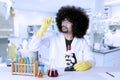 Afro scientist holds microscope slide