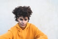 Afro smiling man portrait - Mixed race young guy with curly hair posing in front camera Royalty Free Stock Photo