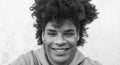 Afro smiling man portrait - Mixed race young guy with curly hair posing in front camera