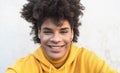 Afro smiling man portrait - Mixed race young guy with curly hair posing in front camera Royalty Free Stock Photo