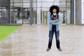 Afro student holds book at school