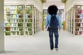 Afro student walks in library