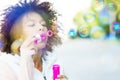 Afro woman blowing soap bubbles Royalty Free Stock Photo
