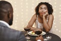 Bored afro woman attending first date at restaurant