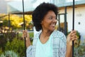 Afro young african american woman smiling while looking away outside house Royalty Free Stock Photo