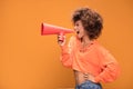 Afro young girl screaming by red megaphone. Royalty Free Stock Photo