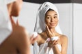 Afro Young Lady Applying Face Cream Standing In Bathroom, Panorama Royalty Free Stock Photo