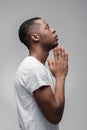 Afroamerican guy praying and asking God. Profile. Royalty Free Stock Photo