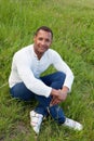 Afroamerican guy sitting on the grass Royalty Free Stock Photo