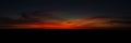 The Afterglow of Sunset, deep velvety red wispy cloudscape against a deep dark blue sky